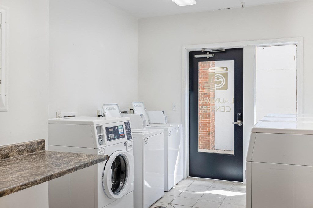 a laundry room with washers and dryers