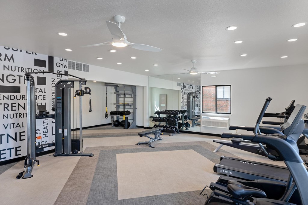 a gym with treadmills and other exercise equipment