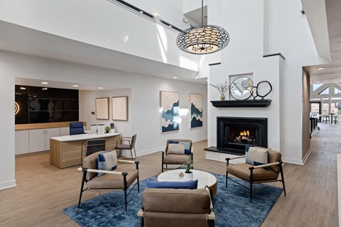 a living room with couches and chairs and a fireplace
