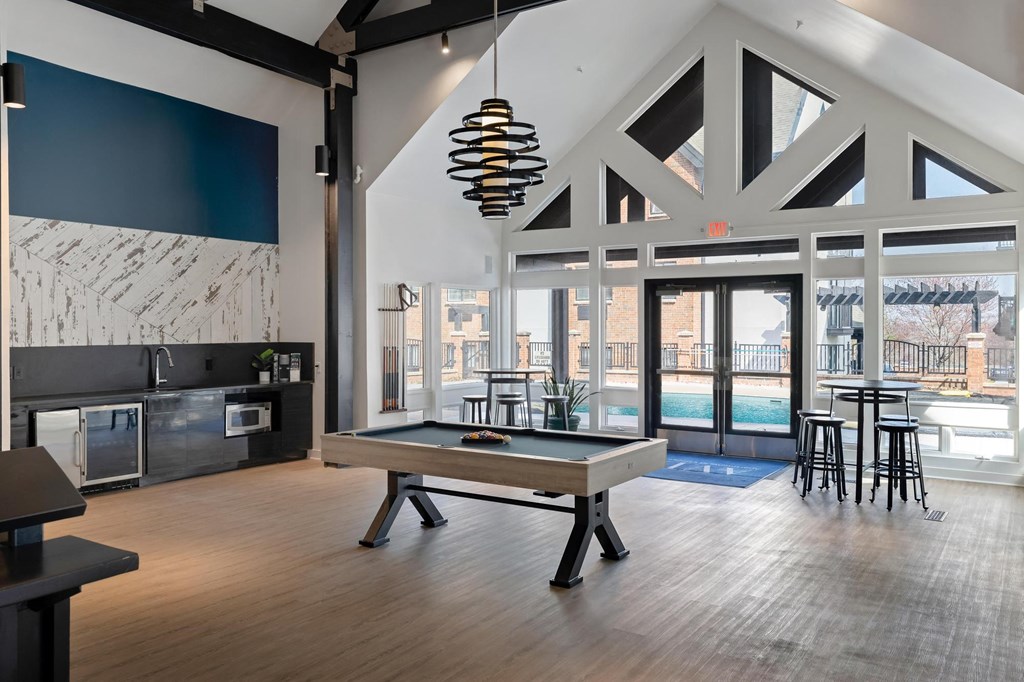 a pool table in the clubhouse at the bradley braddock road station apartments