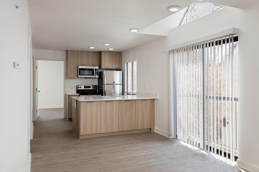 a kitchen with wood floors and white walls