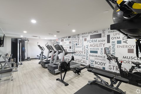 Gym with various machines at Avia Lofts at Maple Road, New York, 14221