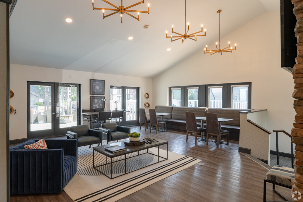 a large living room with couches and chairs and a dining room with a piano