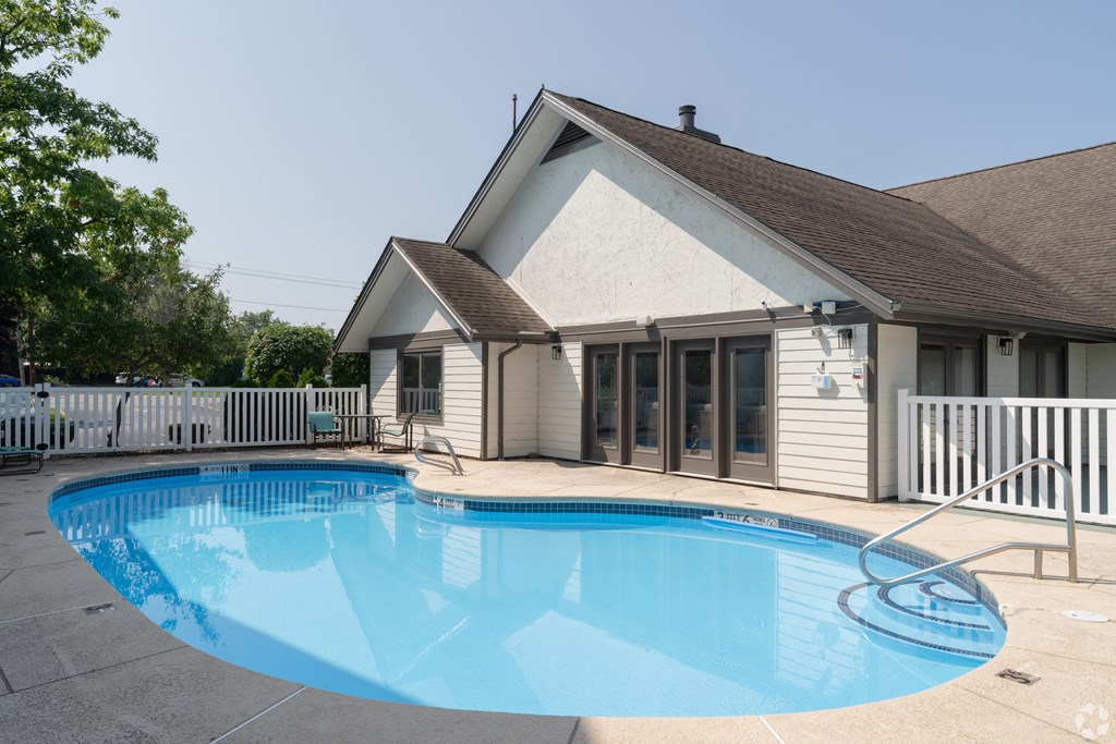 a swimming pool in front of a house