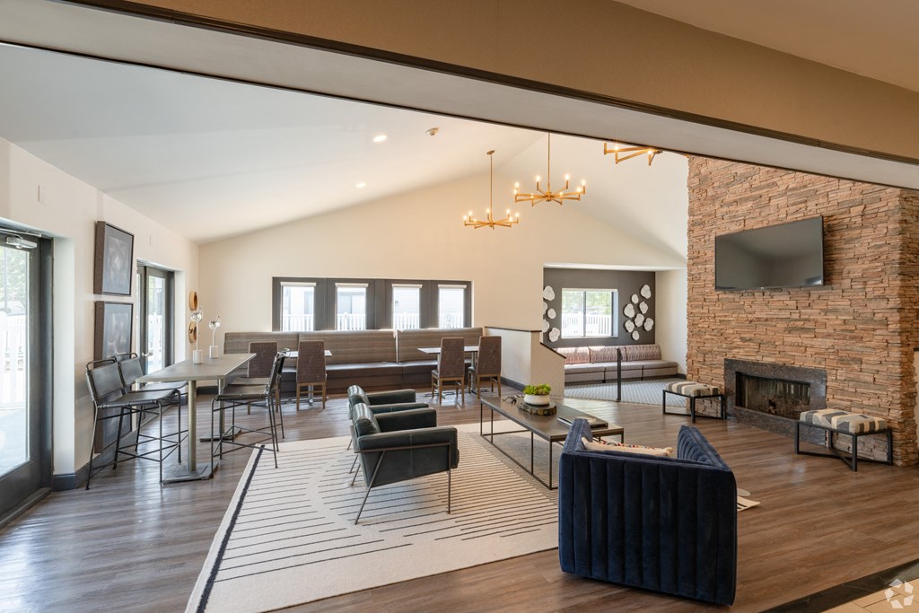 a living room with a fireplace and a table and chairs