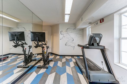 a gym with exercise equipment and a map on the wall