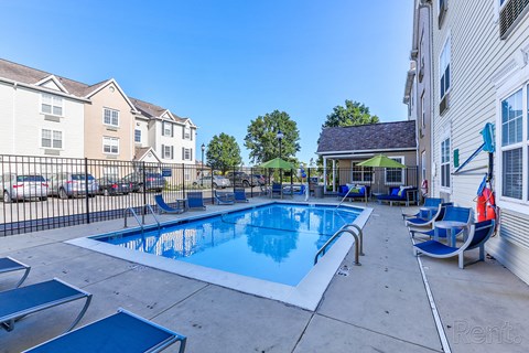 our resort style swimming pool is next to our building with lounge chairs and tables