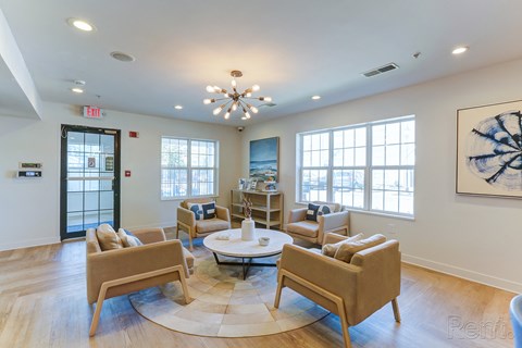 a living room with couches and chairs and a round table
