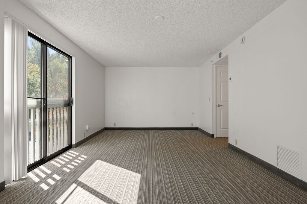 the living room of an apartment with a large window at AVIA Lofts on Parkway Apartments, Vancouver, Washington