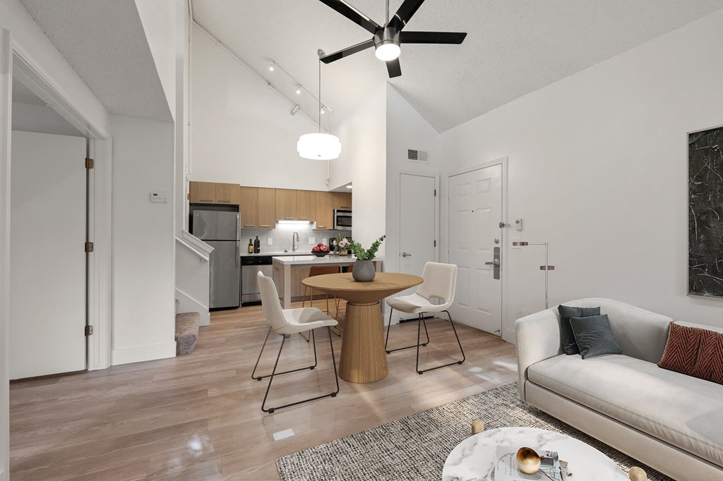 an open living room and kitchen with a table and chairs at AVIA Lofts on Parkway Apartments, Vancouver, WA