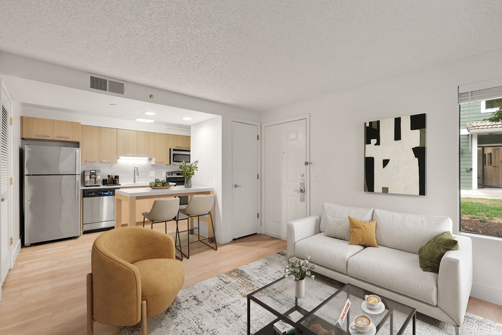 a living room with a white couch and a glass coffee at AVIA Lofts on Parkway Apartments, Washington