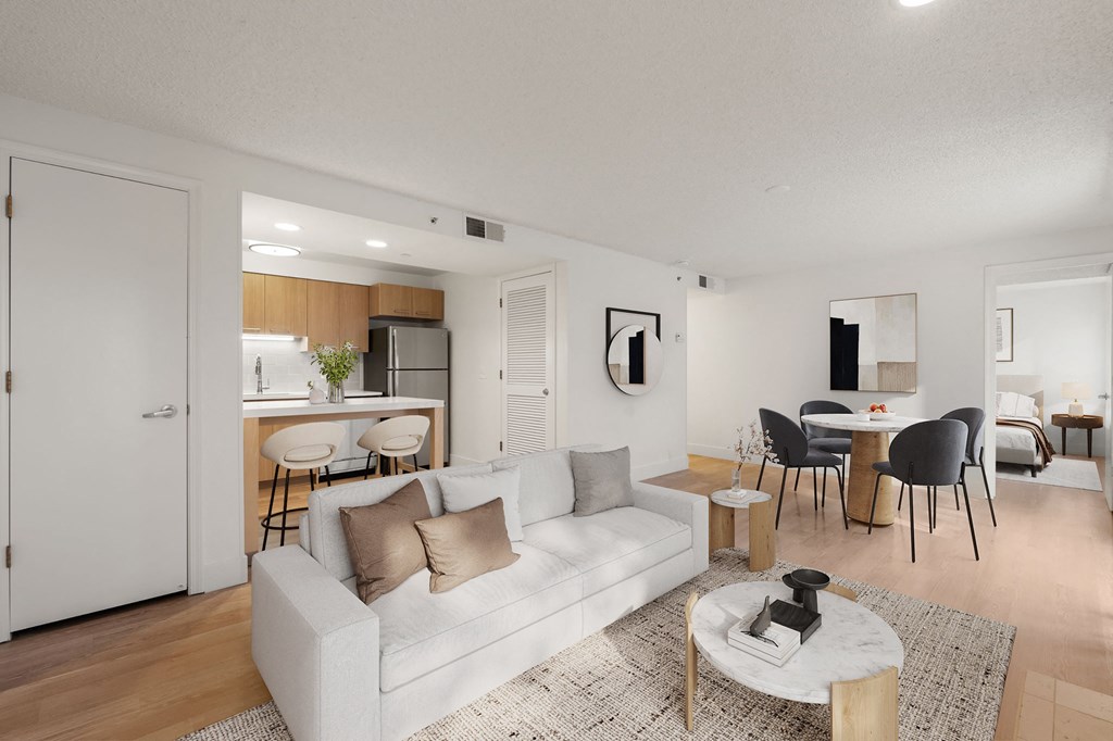 A modern living room with a white couch and a coffee table. at AVIA Lofts on Parkway Apartments, Washington, 98662