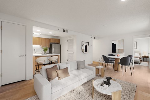 A modern living room with a white couch and a coffee table.