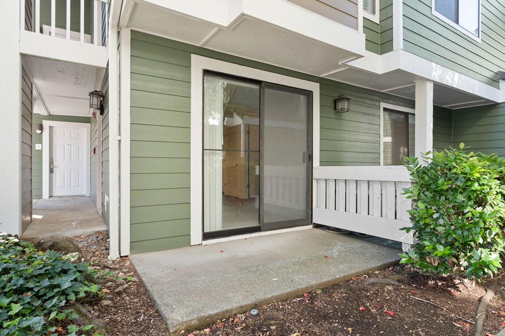 the front porch of a green house with a glass door at AVIA Lofts on Parkway Apartments, Vancouver