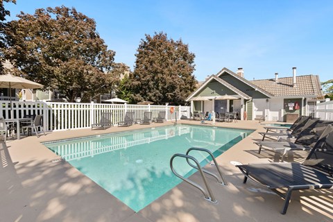 our resort style swimming pool is next to our house with lounge chairs at AVIA Lofts on Parkway Apartments, Vancouver, 98662