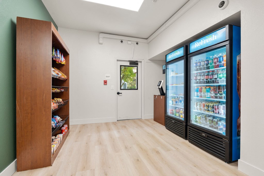 a room with two refrigerators and a counter with a door at AVIA Lofts on Parkway Apartments, Vancouver