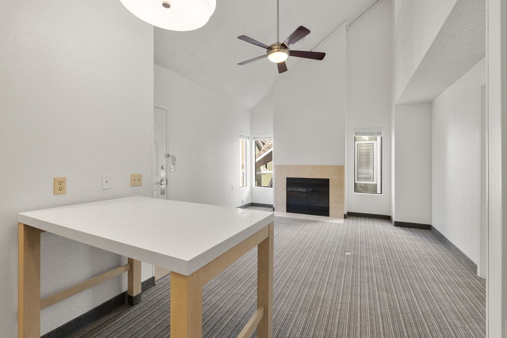 a living room with a white table and a ceiling fan at AVIA Lofts on Parkway Apartments, Vancouver, WA, 98662