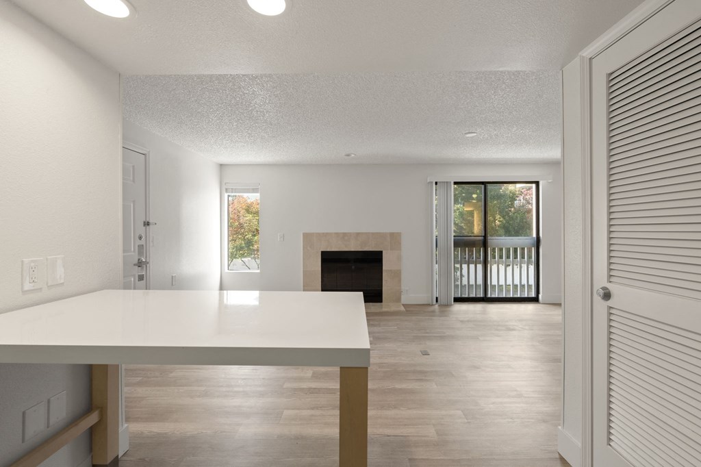 the living room and dining room of a house with a fireplace at AVIA Lofts on Parkway Apartments, Vancouver