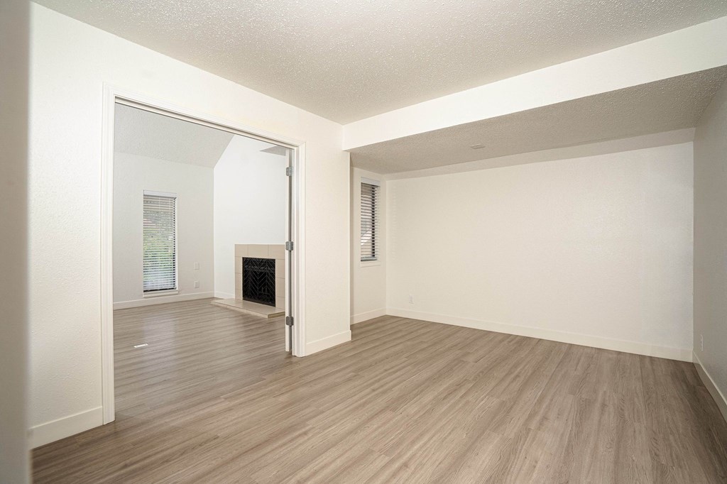 a bedroom with a fireplace and hardwood floors