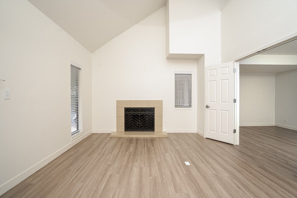 an empty living room with a fireplace