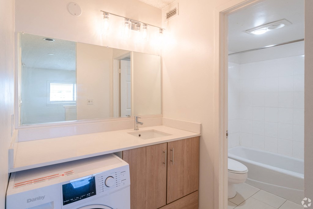 a dryer in a bathroom with a sink and a toilet
