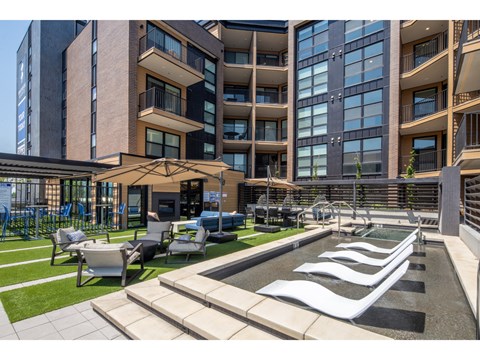Courtyard pool with sun loungers and modern seating at Brickside Heights Apartments, Utah, 84106