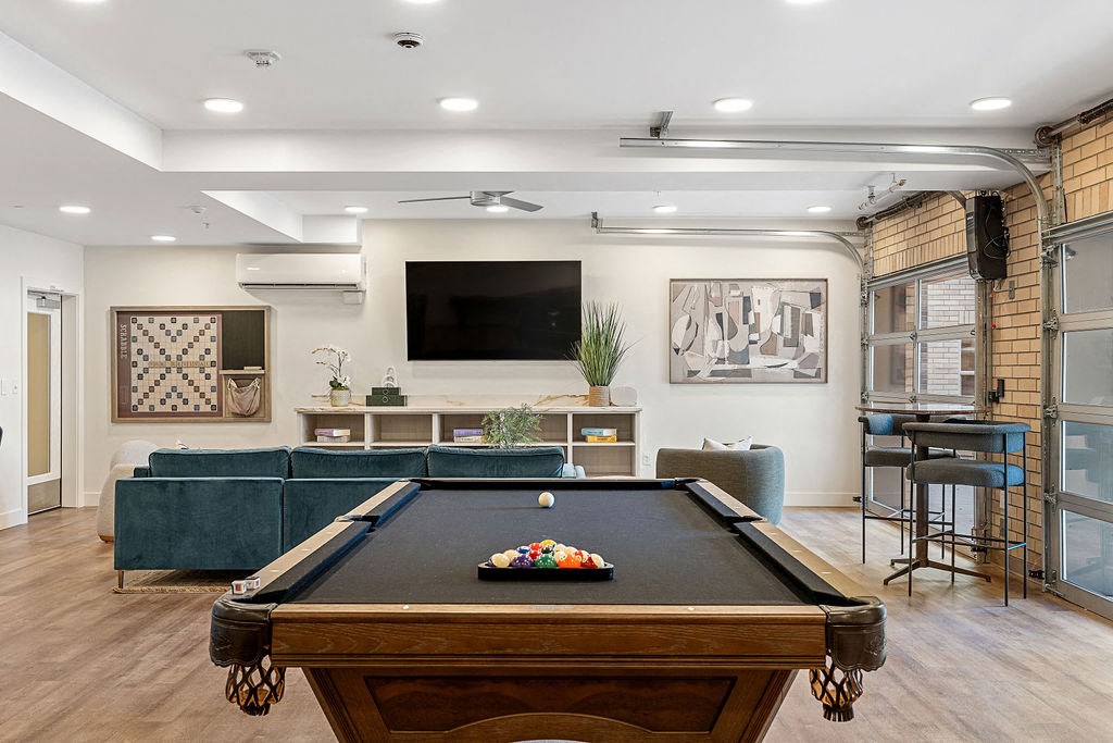 a game room with a pool table and a television at The Revival, Utah