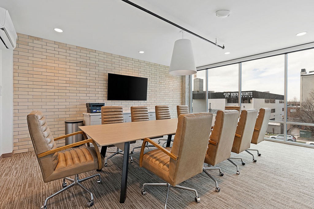 a conference room with a wooden table and chairs at The Revival, Utah