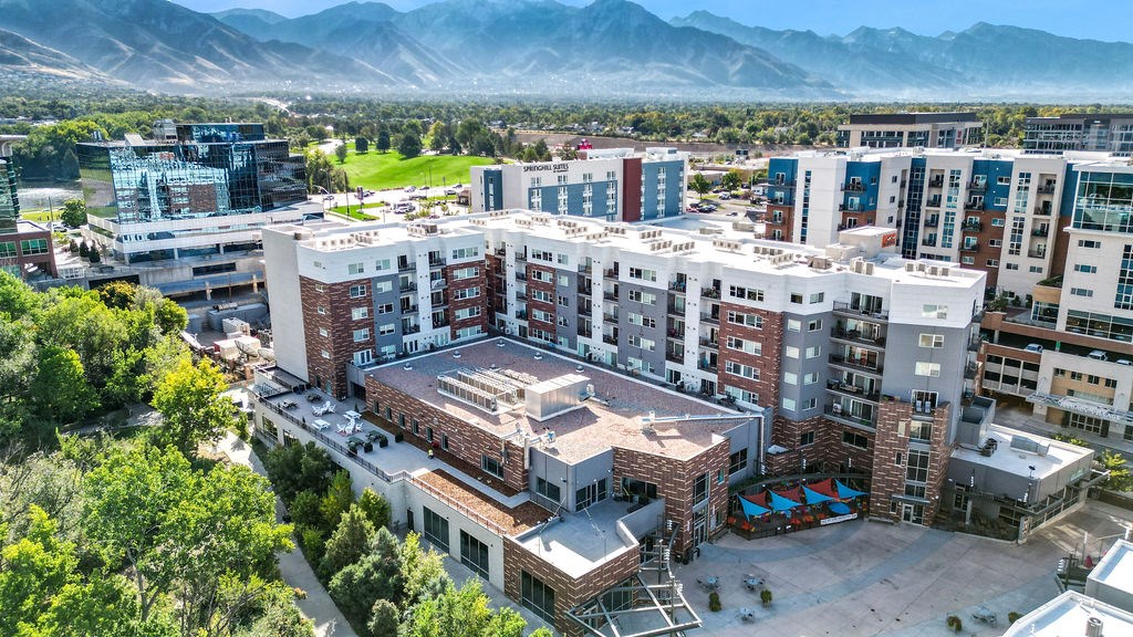 an aerial view of a large apartment complex with a golf course in the background at Wilmington Flats Apartments, Utah