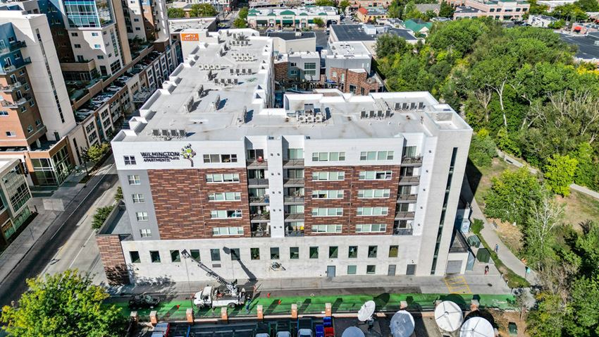 a view from above of a large white building with a green lawn in front of it