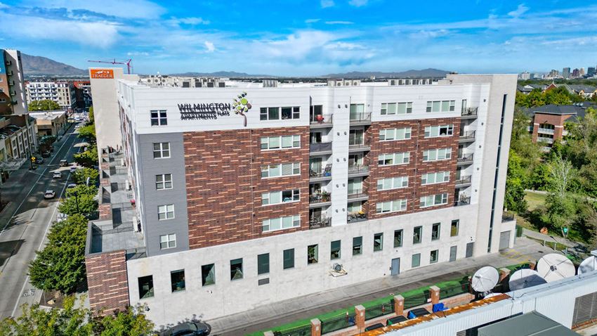 a large white building with a blue sky in the background