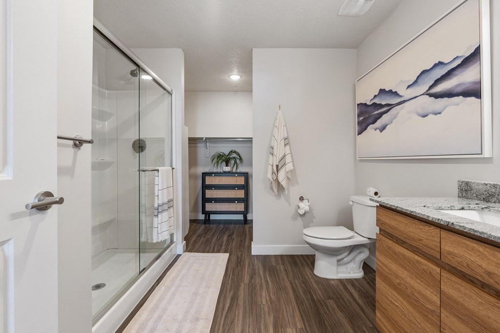 a bathroom with a glass shower and a toilet at The Flats at Riverwoods, Provo, 84604
