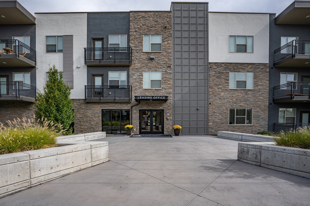 an empty courtyard in front of an apartment building at The Flats at Riverwoods, Provo, 84604