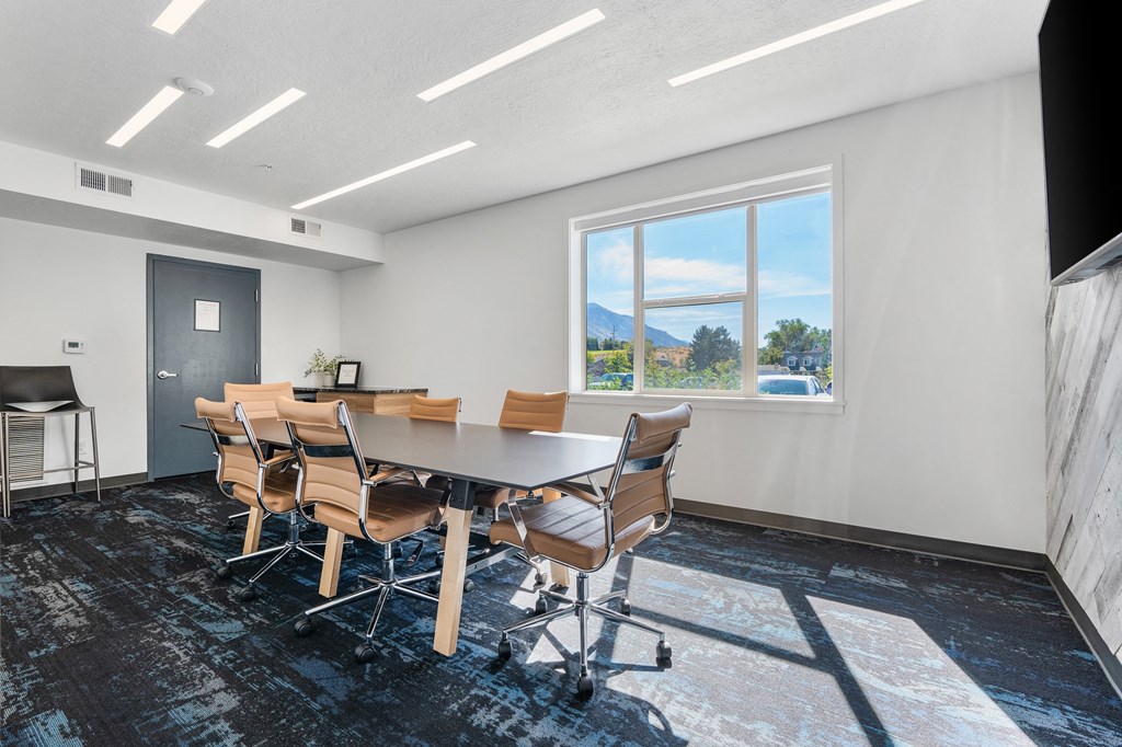 a conference room with a table and chairs and a window at The Flats at Riverwoods, Provo, 84604