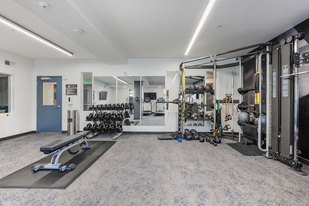 the preserve at ballantyne commons fitness room with weights and cardio equipment at The Flats at Riverwoods, Provo, Utah