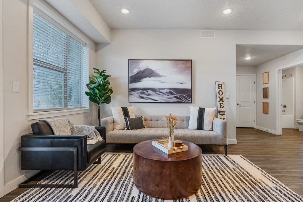 a living room with a couch and a coffee table at The Flats at Riverwoods, Provo, Utah