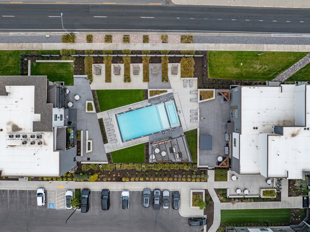 an aerial view of a mansion with a large swimming pool in the center of it at The Flats at Riverwoods, Provo, Utah
