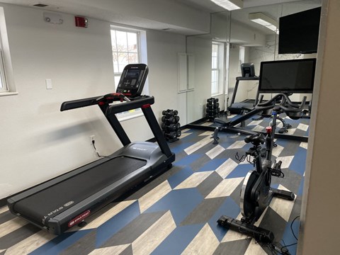 a gym with treadmills and other exercise equipment in a building