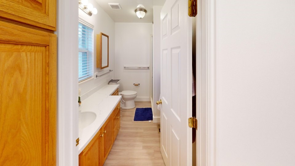 A bathroom with a toilet, sink, and bathtub.