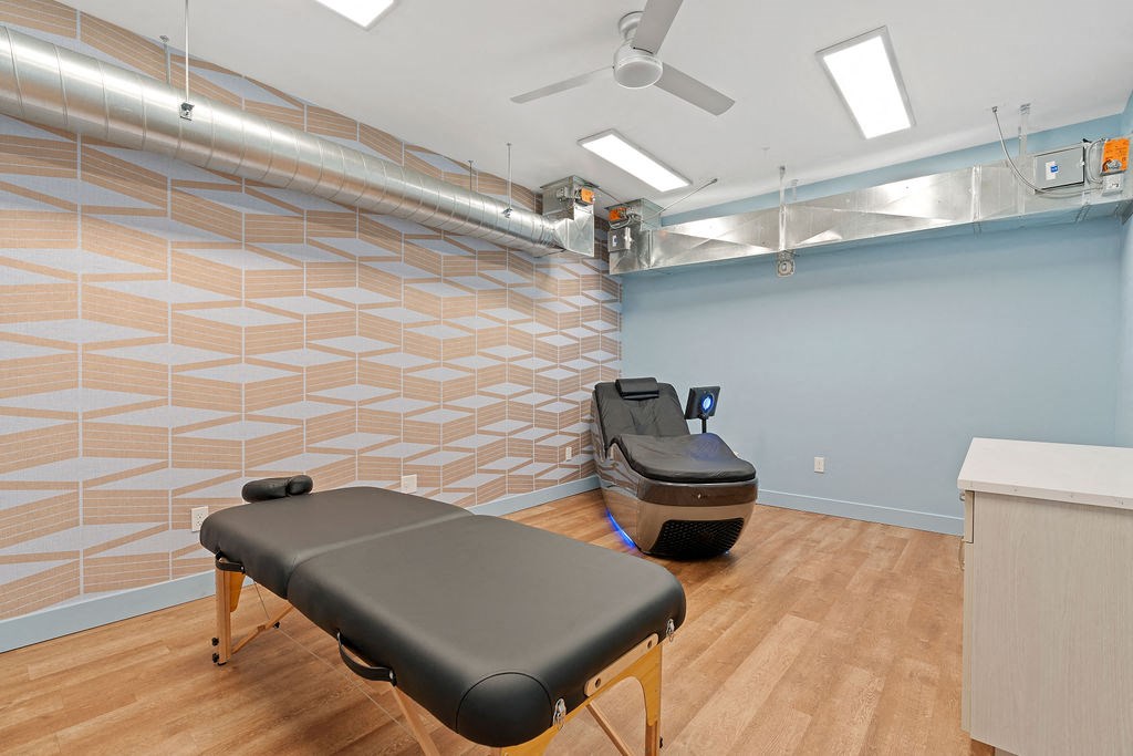 a treatment room with a massage chair and a at The Revival, Salt Lake City