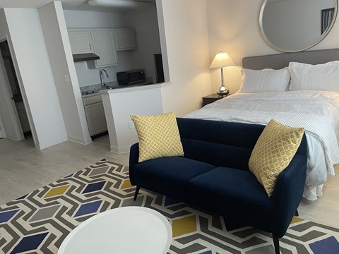 a bedroom with a couch and a table and a bed