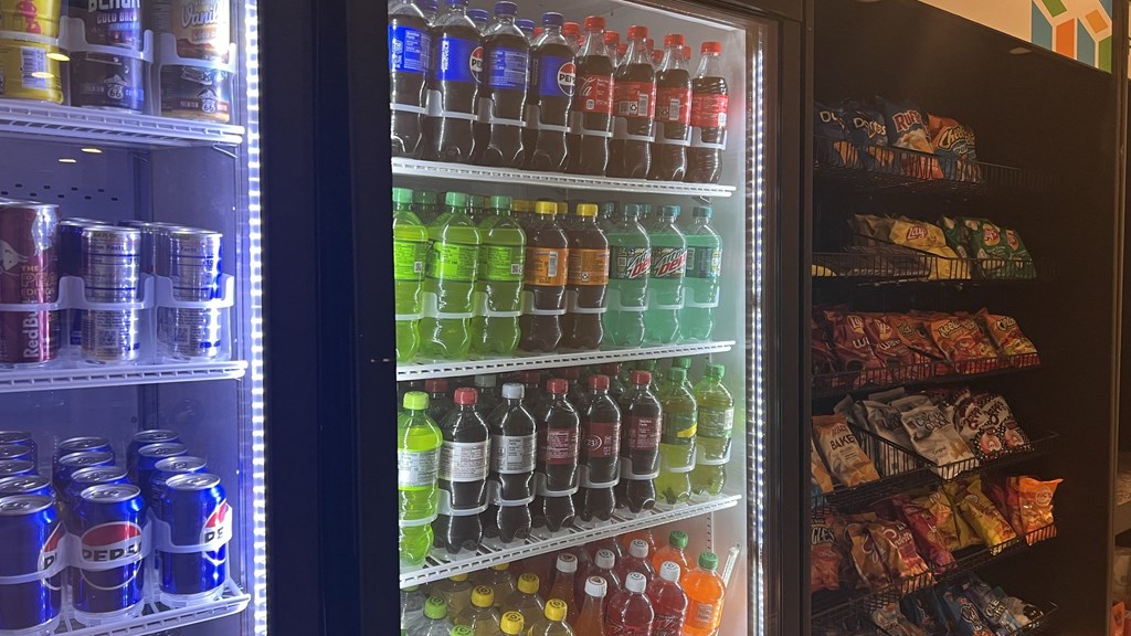 a refrigerator filled with soda and other drinks