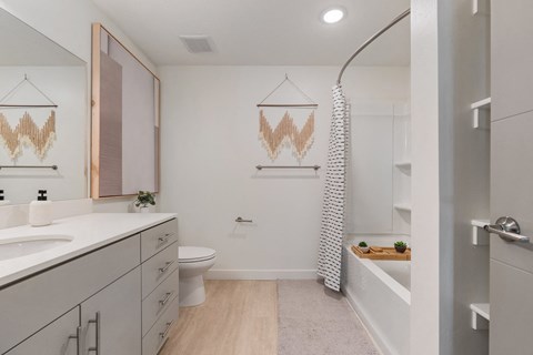 a bathroom with white cabinets and a white toilet and a tub at Paperbox Lofts, Salt Lake City, UT, 84101