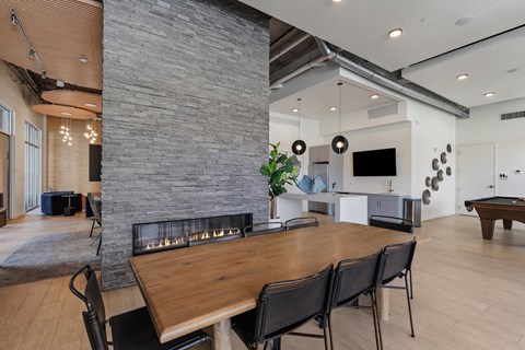 a living room with a fireplace and a wooden table at Paperbox Lofts, Salt Lake City, UT