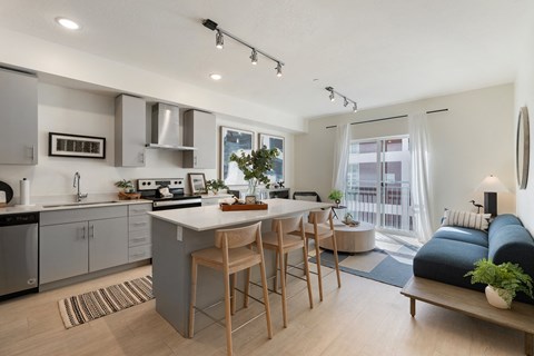 a kitchen and living room with an island and a couch