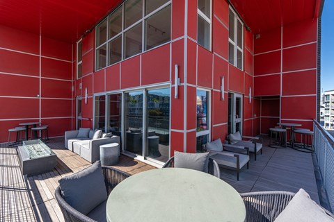 a large red building with tables and chairs outside of it at Paperbox Lofts, Salt Lake City, UT, 84101