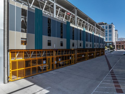 the side of a building with a yellow barricade and a blue and white facade at Paperbox Lofts, Salt Lake City, Utah