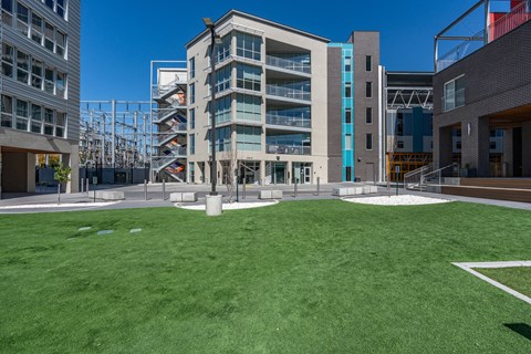 a lawn in front of a building with grass at Paperbox Lofts, Utah