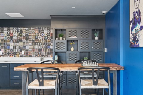 a dining room with tables and chairs and blue walls at Paperbox Lofts, Salt Lake City, UT