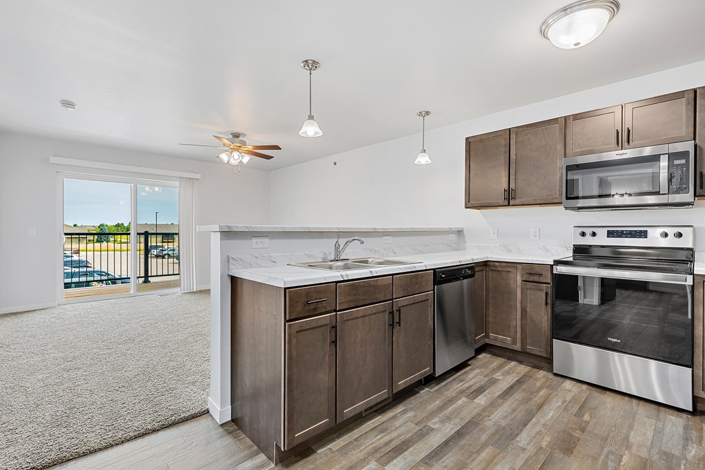 a kitchen with wooden cabinets and stainless steel appliances